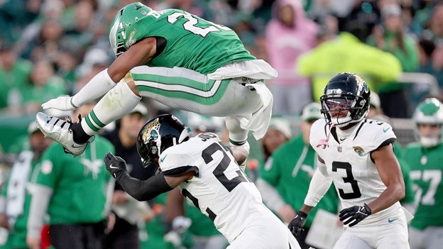 Eagles Running Back, Saquon Barkley doing a backward hurdle over jaguars Defensive player. (Cbs Sports)  